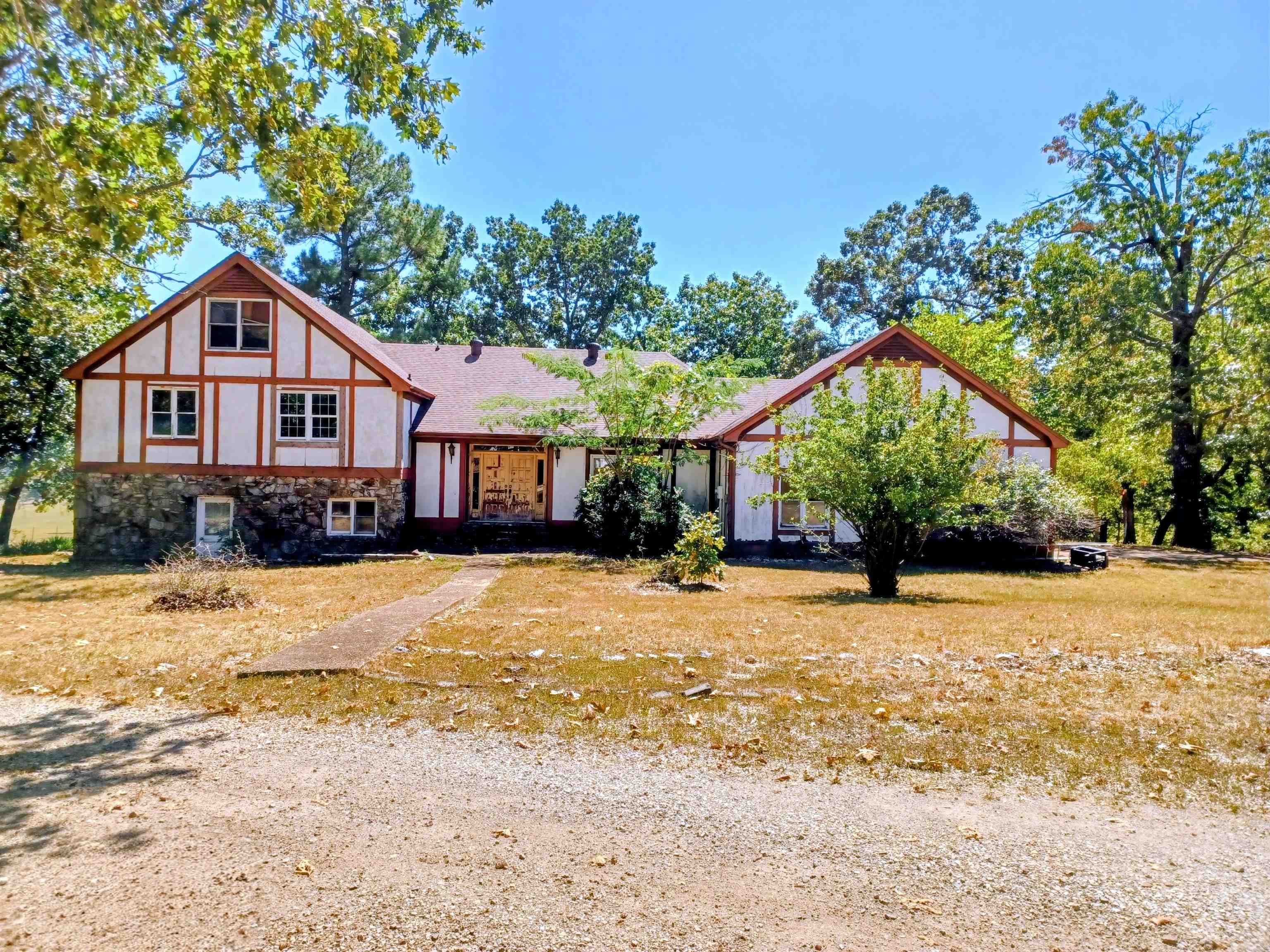 They say Arkansas is the natural state. Hereās your chance to own a gem. This diamond in the rough is 5 bedrooms, could possibly be six bedrooms and 3 full bathrooms. Tudor style home sits on over 5 acres, with views of the mountains. The main floor has a big eat in kitchen, with double wall ovens and gas range. Formal dining room, with a big window to watch the deer. Step down formal living. A secret closet with a staircase leading up to a huge walk in attics space.The upstairs has 3 bedrooms, possibly 4 and two full bathrooms. There is a small staircase in one room that leads up to 2 more bedrooms. The downstairs showcases a gorgeous stone fireplace. A full bathroom and library room. It has a space for a downstairs kitchen or wet bar. Downstairs space has its own entrance so it could be an in law suite. The possibilities are endless with this gem. This would make a great investment property for somebody willing to do the work. Call me today to this property.