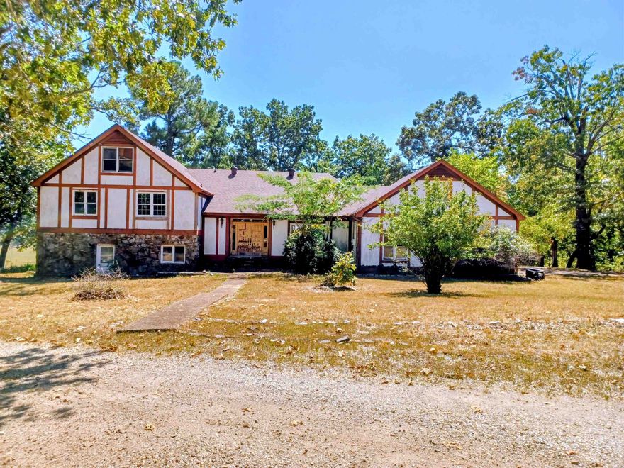 They say Arkansas is the natural state. Here’s your chance to own a gem. This diamond in the rough is 5 bedrooms, could possibly be six bedrooms and 3 full bathrooms. Tudor style home sits on over 5 acres, with views of the mountains.  The main floor has a big eat in kitchen, with double wall ovens and gas range. Formal dining room, with a big window to watch the deer. Step down formal living. A secret closet with a staircase leading up to a huge walk in attics space.The upstairs has 3 bedrooms, possibly 4 and two full bathrooms. There is a small staircase in one room that leads up to 2 more bedrooms. The downstairs showcases a gorgeous stone fireplace. A full bathroom and library room. It has a space for a downstairs kitchen or wet bar. Downstairs space has its own entrance so it could be an in law suite. The possibilities are endless with this gem. This would make a great investment property for somebody willing to do the work. Call me today to this property.