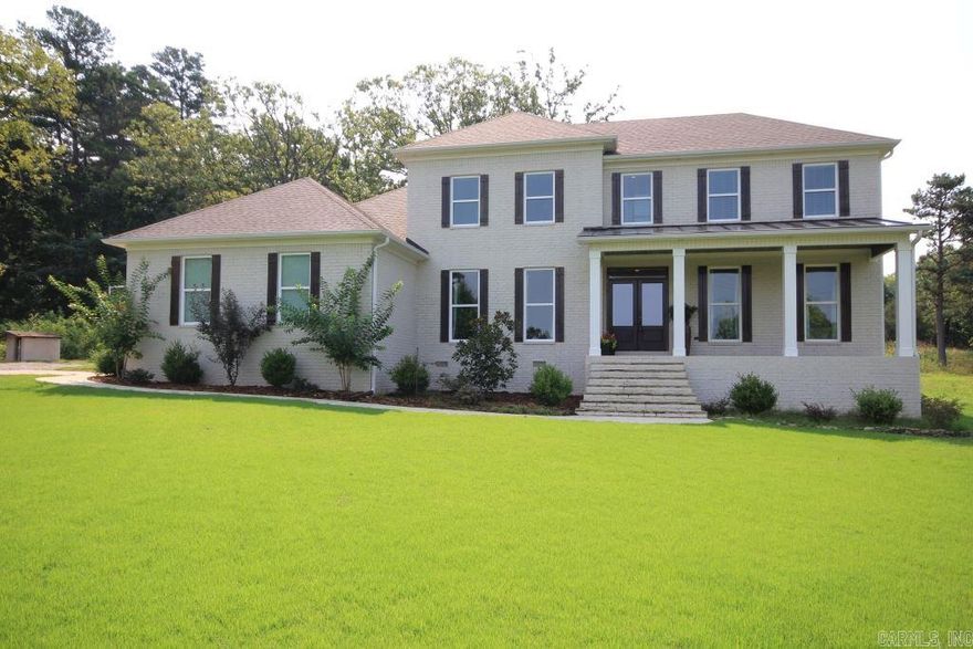 Beautiful newer home in the country! This 4 bedroom 3 1/2 bath features master and guest bedrooms on main level, hardwood floors, custom paint and large airy kitchen overlooking the backyard.  Main level office (or Dining room).  Covered porches on front and back are great for entertaining.  The upstairs has 2 bedrooms, large Jack & Jill bath, bonus room, floored attic storage and laundry chute as well. Two 50-gallon hot water heaters.  Come see!