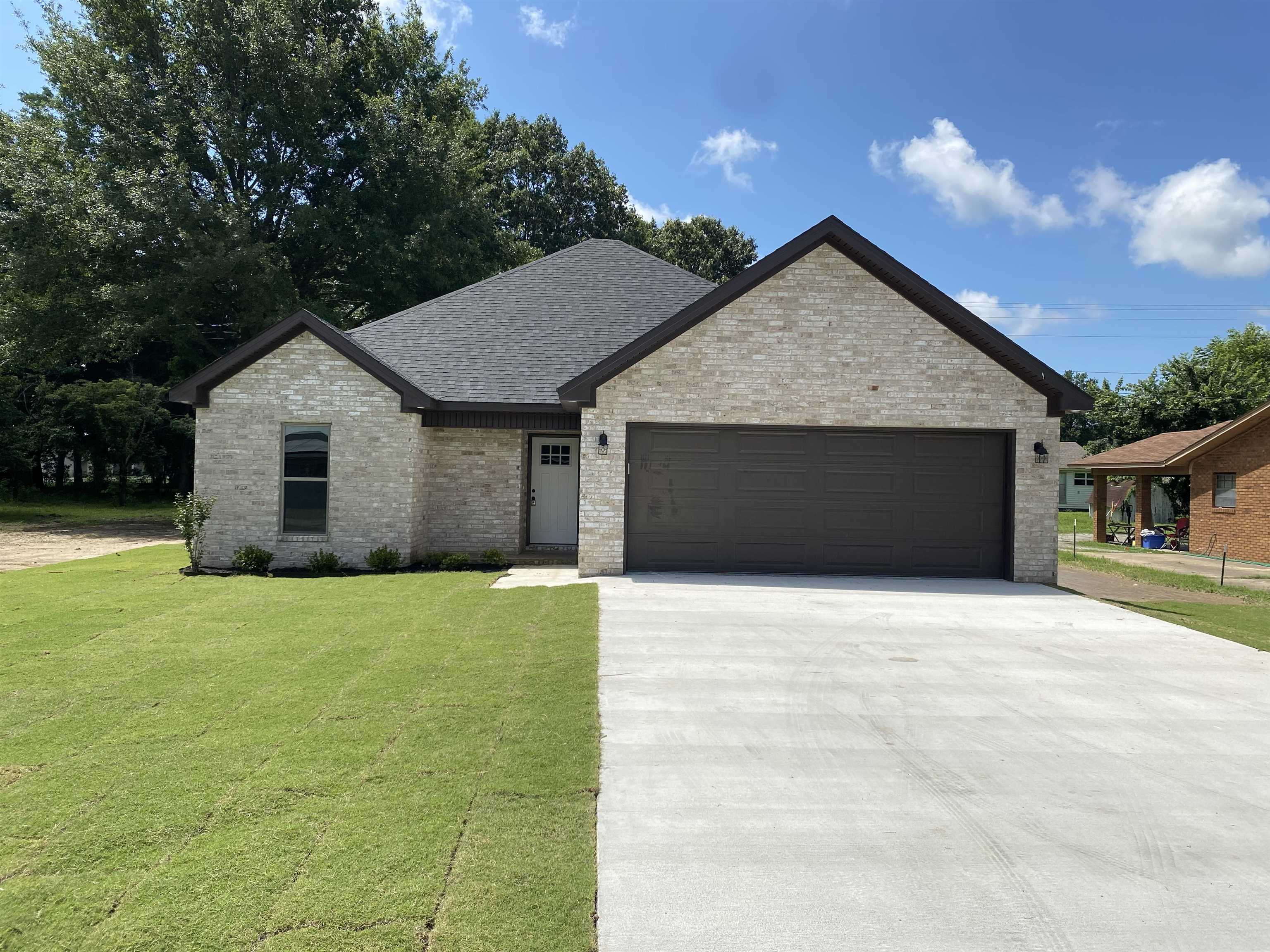 New brick beauty located in a fantastic, well established neighborhood, not in flood zone. 3 bedroom, 2 bath with vaulted ceiling and gas log fireplace in the living. Eat-in kitchen with corner sink. Wood look ceramic tile throughout. His/her closets in the primary bathroom. 2-car garage with front and back porch. Jonesboro Arkansas is a short 15 minute drive, Memphis is about an hour away. Plan to make 231 Flossie Trumann AR your next home.