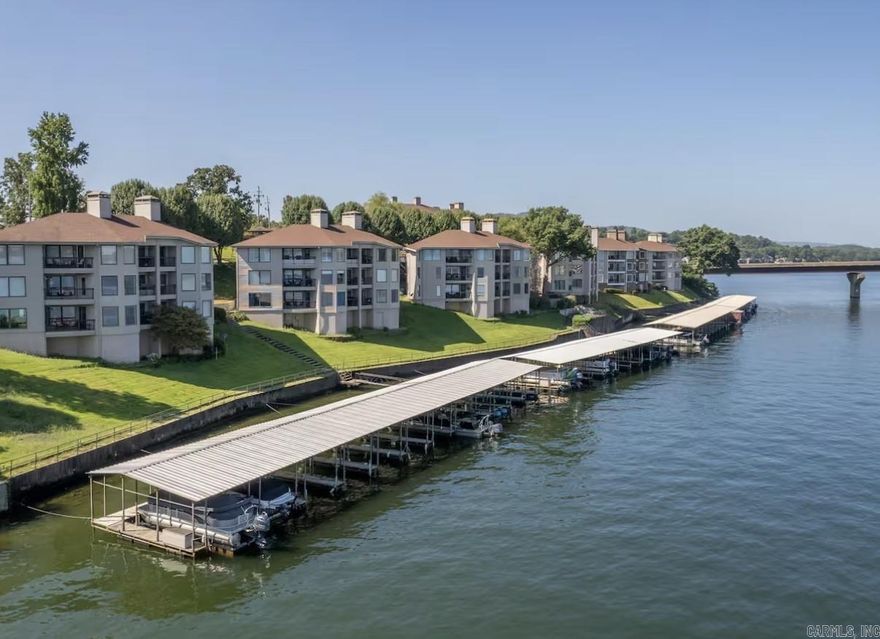 Bring your boat! This fully furnished, move-in ready condo offers the ultimate lakefront lifestyle. Perfectly positioned in the heart of it all, you’ll enjoy breathtaking 180° views of Lake Hamilton right from your own balcony. Inside, the condo features stylish modern décor and a comfortable, inviting layout. Its prime location puts you just minutes from Oaklawn Racing Casino Resort, dining, shopping, art galleries, movie theaters, and endless outdoor recreation. A private boat dock provides effortless access to the water, making it easy to spend your days on the lake and your evenings unwinding with stunning sunset views. Residents also enjoy exceptional POA amenities, including a swimming pool, hot tub, clubhouse, and the added peace of mind of a gated community.