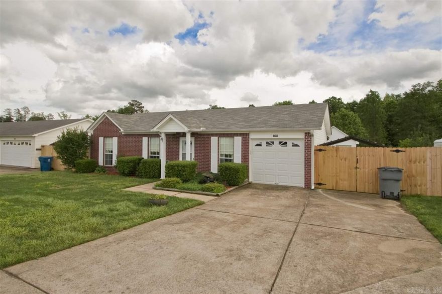 Adorable house 3 bedrooms, 2 bathrooms.  Newly painted bathrooms and hall, eat in kitchen, fenced backyard.  1 Car garage, extra parking pad extending into backyard with carport.  covered patio, large shop/storage building in back.  Washer/dryer/refrigerator and microwave to convey.  Water feature in front yard.  Front yard will be mowed by POA if requested, gates maintained by POA if requested.