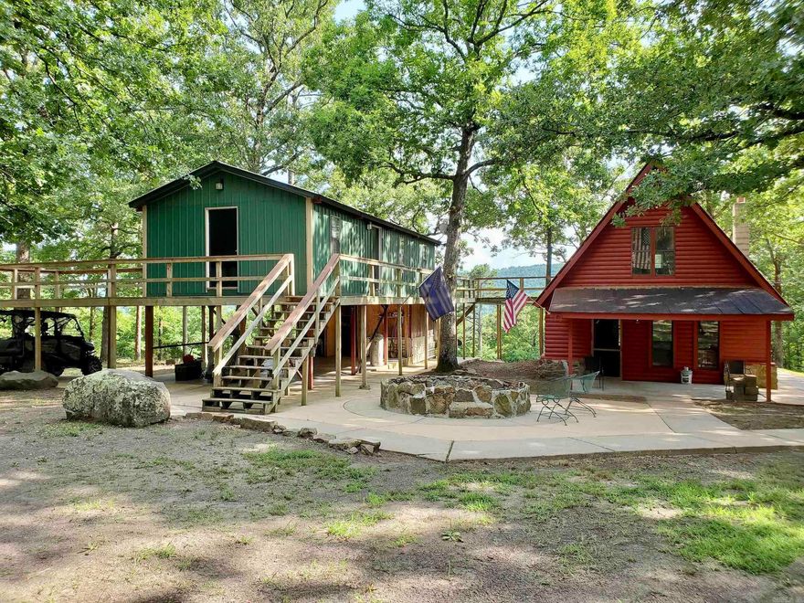 Opportunities like this don’t come around often—one cabin nestled in the National Forest is rare, but two on the same property is nearly unheard of! If you're seeking a peaceful escape to hunt, fish, ride, and relax, this retreat delivers it all and more. Bordering U.S. Forest Service land on three sides, this private sanctuary features two fully remodeled cabins connected by a charming wooden walkway, offering approximately 1,800 sq ft of cozy living space. The main cabin offers two bedrooms and two full bathrooms. In contrast, the second cabin features one bedroom and one bathroom—perfect for hosting guests, multigenerational use, or even short-term rental potential. Both cabins include full kitchens, modern comforts, and on-site utilities, including rural water and electricity. Step out your door and into nature with direct access to the Ozark-St. Francis National Forest, and enjoy proximity to local attractions like the Long Pool Recreation Area, Moccasin Gap ATV trails and the famed Dover Lights. Whether you're looking for a weekend getaway, hunting camp, or a multi-cabin investment property, this one-of-a-kind retreat is ready to welcome you home to the woods.