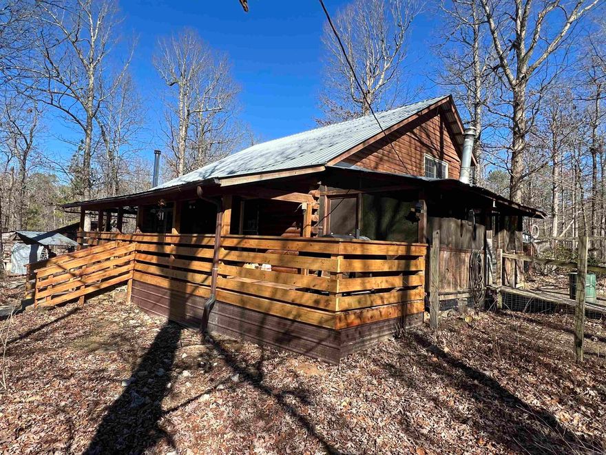 Price Improvement!!! Looking for a Ozarks Cabin Retreat, not too far from town?  This is the one to take a look at.  The Blue Mountain Log Cabin has 1,512 +/- square feet of living area with 4 bedrooms and 2 bathrooms.  Most of the interior walls were recently covered in tongue and groove Northern White Cedar, enhancing the cozy ambiance of the cabin.  The main floor has a living room with wood burning stove, eat in kitchen, and large walk-in pantry with laundry room.  The second floor has 3 bedrooms and 1 bathroom with a walkway overlooking the living, dining and kitchen on the main floor below.  In the event the power goes out, there is an on-demand propane generator that will keep the lights on.  The front porch has been completely rebuilt from the ground up, creating a great place to entertain with an added area for your smoker and grill that connects to the screened in side porch with its antique wood cook stove.   The cabin sets on 6.98 +/- acres, .2 miles off Highway 66.  This property is ideal for homesteading with garden spots, chicken coop, and outbuildings for animals.