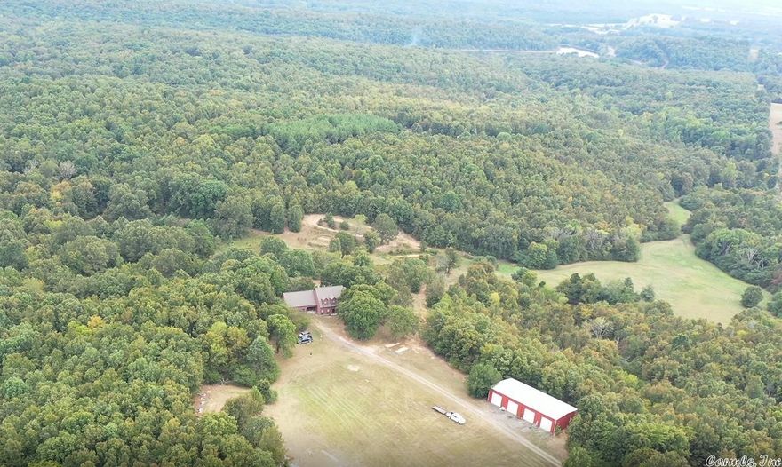 PRICE JUST REDUCED $25k to allow for updates! 130 Acres of Nature Lover's Paradise adjoining the 375-acre Woolly Hollow State Park with the 40-acre Lake Bennett.  This 3000 sq ft home with 2-car garage and 36'x80' shop with 16' sidewalls, sits on a beautiful 130 acres with an unbelievable view.  The property is filled with deer and other wildlife.  Approx. 102 of the 130 acres is covered in both Pine and Hardwood Forests. Check out the video of the property.