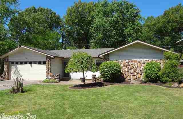 Open versatile floor plan home features formal dining area, family room, huge sun room, eat-in kitchen, breakfast bar, tile floors throughout, natural rock fireplace with stove insert, new dishwasher, custom oak cabinetry with fold out pantry, smooth top stainless range, refrigerator conveys, maintenance free exterior, newer roof, extended driveway for extra parking, large level lot with plenty of backyard space, covered back patio, & 14 X 20 single bay workshop wired for electricity. See Agent Remarks....