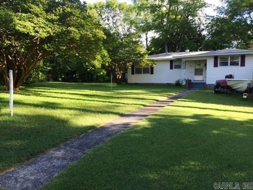 This is a great solid built home on a corner lot close to Fitness Unlimited.  Featuring large fenced in back yard and a work shop.  It has a covered patio, wood burning fireplace, separate dining room, large laundry room, four bedrooms and adorable kitchen with gas range. Original wood flooring throughout house, new roof in 2011. Refrigerator to convey with property. This home is located in an established neighborhood with easy access to I-30. Very motivated seller. Come take a look today!!