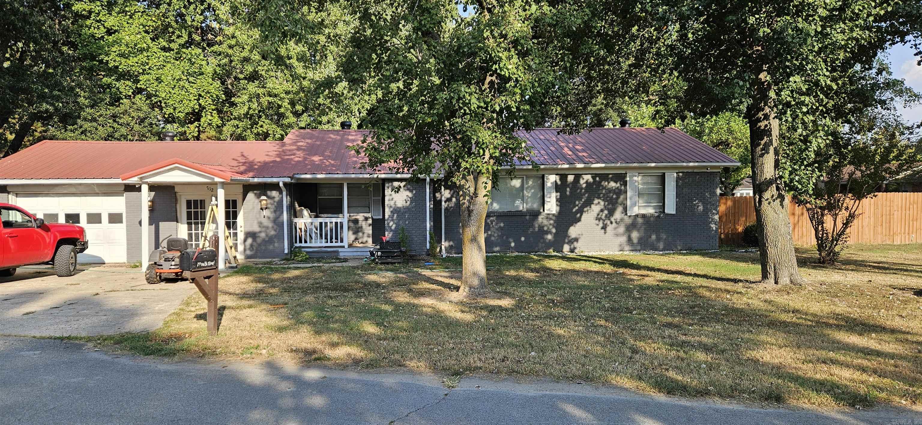Step into a spacious brick home nestled on a corner lot—where natural light fills the rooms and mature trees offer shade and serenity. Whether you're settling down or scaling up, this property delivers flexibility, charm, and investment potential. • 3 Bedrooms 2 Full Bathrooms • Dual living spaces: Living room + family room • Eat-in kitchen with warm oak cabinetry • Central heat & air for year-round comfort • Attached single-car garage • 16' x 30' outbuilding—perfect for storage, hobbies, or workshop • Worry-free from electrical outages with a Generac home generator • Public utilities: water, sewer, electric, gas