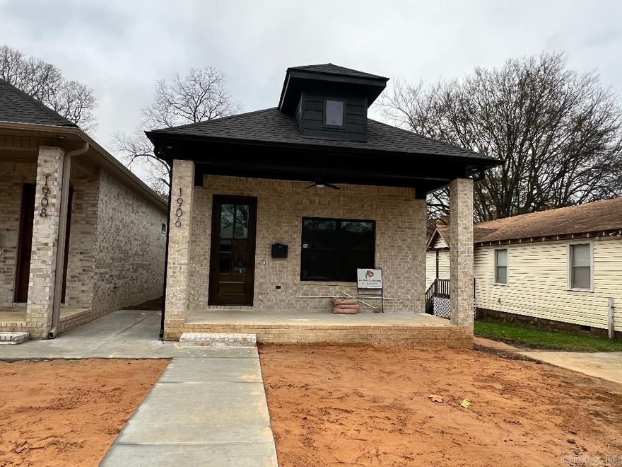 Indulge in the elegance of this brand new all-brick two bedroom, two bathroom shotgun house. Boasting custom cabinets, granite counter tops, beautiful light fixtures, and ceiling fans, this exudes sophistication. With 10-foot ceilings, 8-foot doors, LVP floors, beautiful tile bathrooms, gas cooking, dishwasher, tankless water heater, 5 ceiling fans, recessed lighting, security system.  every detail has been considered. The rear parking pad and low-maintenance small yard complete this luxurious package.