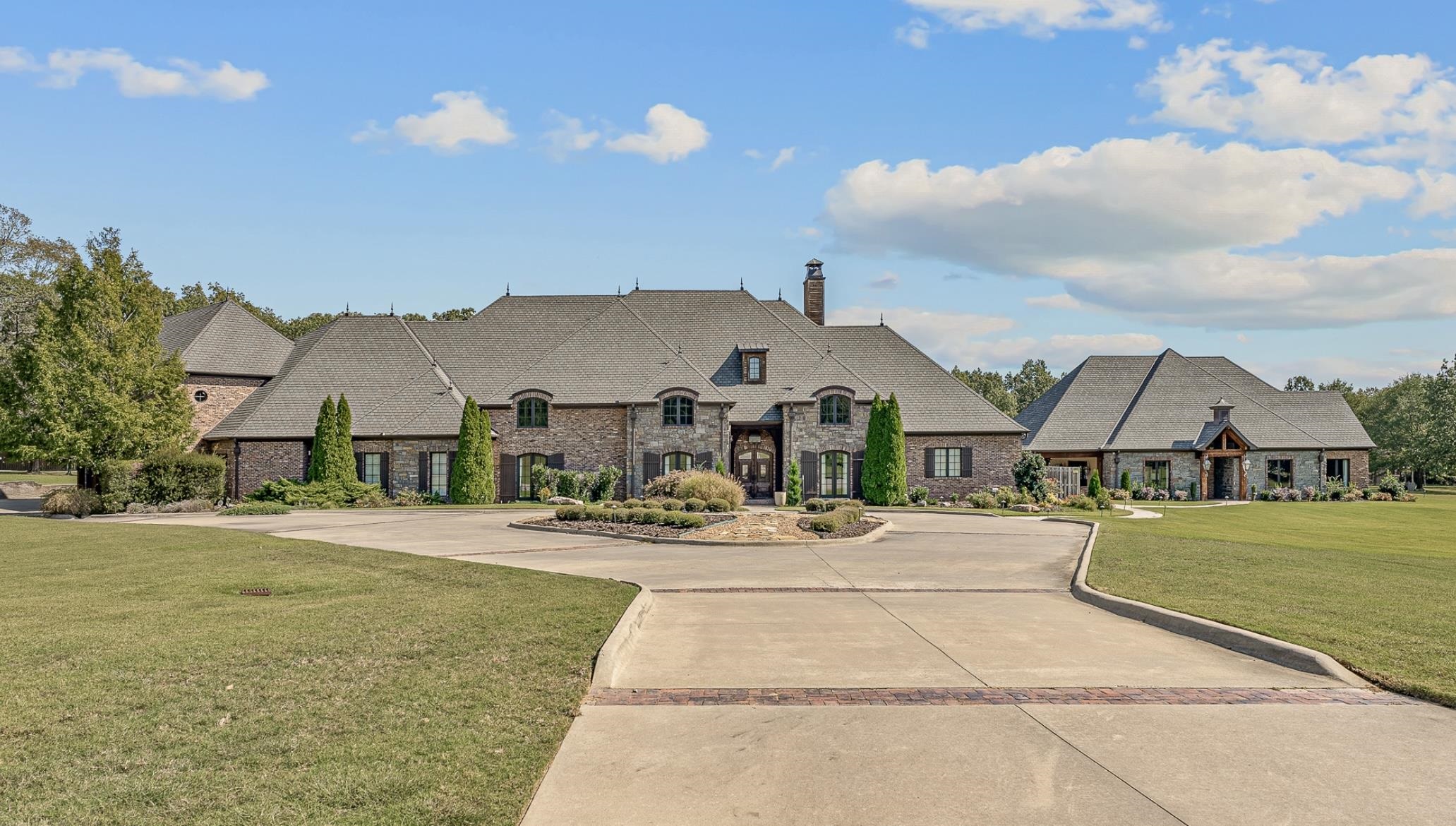Discover a rare 15-acre private estate featuring nearly 10,000 SF across a Main House, Guest House, and Pool House by Nelson Design Group. Includes 6 beds, 6 full & 3 half baths, 18-ft vaulted ceilings, timeless design, & expansive master suite w/ luxury bath & dual closets. Each guest suite has a private bath & walk-in. Enjoy 2,200+ SF of covered outdoor space, media room w/ projector & Dolby sound, 3.5 kitchens, and a stocked 30-ft-deep pond. Guest house offers 2 beds, kitchen, bath, and living room. The Pool House includes a full bar, lounge, catering room, sauna, and bath—ideal for events. A 4,200 SF barn/event center adds to the entertainment value. Front acreage has development potential. A unique lifestyle & investment opportunity!