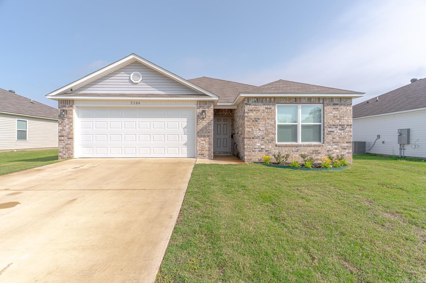 Welcome to Market 5304 Yukon Drive of the Prospect Farms Subdivision in Jonesboro, Arkansas within the Nettleton School District. Situated on a .18 +/- acre lot is a 2023 built Rausch Coleman Taylor featuring 1,523 sf of well laid out living space over a split and open floor plan. The house is wrapped in brick & vinyl, topped with 3-tab shingles, and accented by a front porch, back patio, 2 car garage, and a beautiful flower bed. The interior holds an open concept living/kitchen/dining area, Master bedroom with an en-suite that holds a vanity, shower/tub combo, and two walk-in closets, two spare bedrooms, spare bathroom with shower/tub combo, and laundry room. You'll love that it's all electric, the contemporary color palette, bar seating in the kitchen, vinyl flooring, and the Seller improvements: ceiling fans, cabinet pulls, blinds, plywood in the attic, attic stairs, updated kitchen faucet, and landscaping. Conveniently located near favorite local amenities such as NEA Hospital, Arkansas State University, and retail & dining establishments with easy access to Highway 18. Call today to schedule your tour and make this house your home or next addition to your rental portfolio.