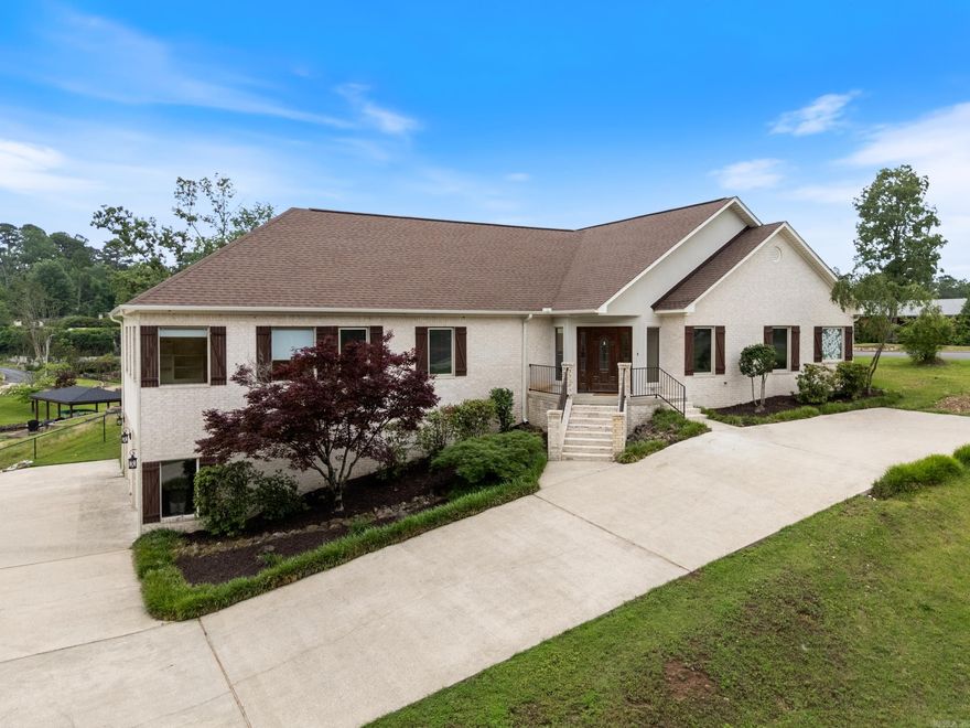 Your Lake Hamilton escape awaits with unforgettable lakeside adventures and gatherings of family and friends. This is the perfect location on a quiet cove, under an hour from Little Rock and only 10 minutes to the fun of Oaklawn! Step inside to a spacious, open floorplan, vaulted ceilings and floor to ceiling windows framing the lake view. The large, well-equipped kitchen features expansive counter space and bar seating open to the dining and living areas. The vaulted ceiling carries through to the covered outdoor veranda - the perfect space for lakeside evenings. A 2nd living area offers fun away from the primary suite. All 3 main-level bedrooms boast ensuite bathrooms. The primary suite features custom built-ins & a walk-in closet connecting two full baths; one with a soaking tub & the other a walk-in glass shower. The full-house speaker system is wired for "party mode" to crank the tunes after a day of fun on the lake! A whole-house vacuum makes cleanup easy. The oversized garage includes HVAC, perfect for storing gear or even a game room, and a large storage room and extra pantry for chilled lake beverages. Permitted dock replacement scheduled to be built in August.
