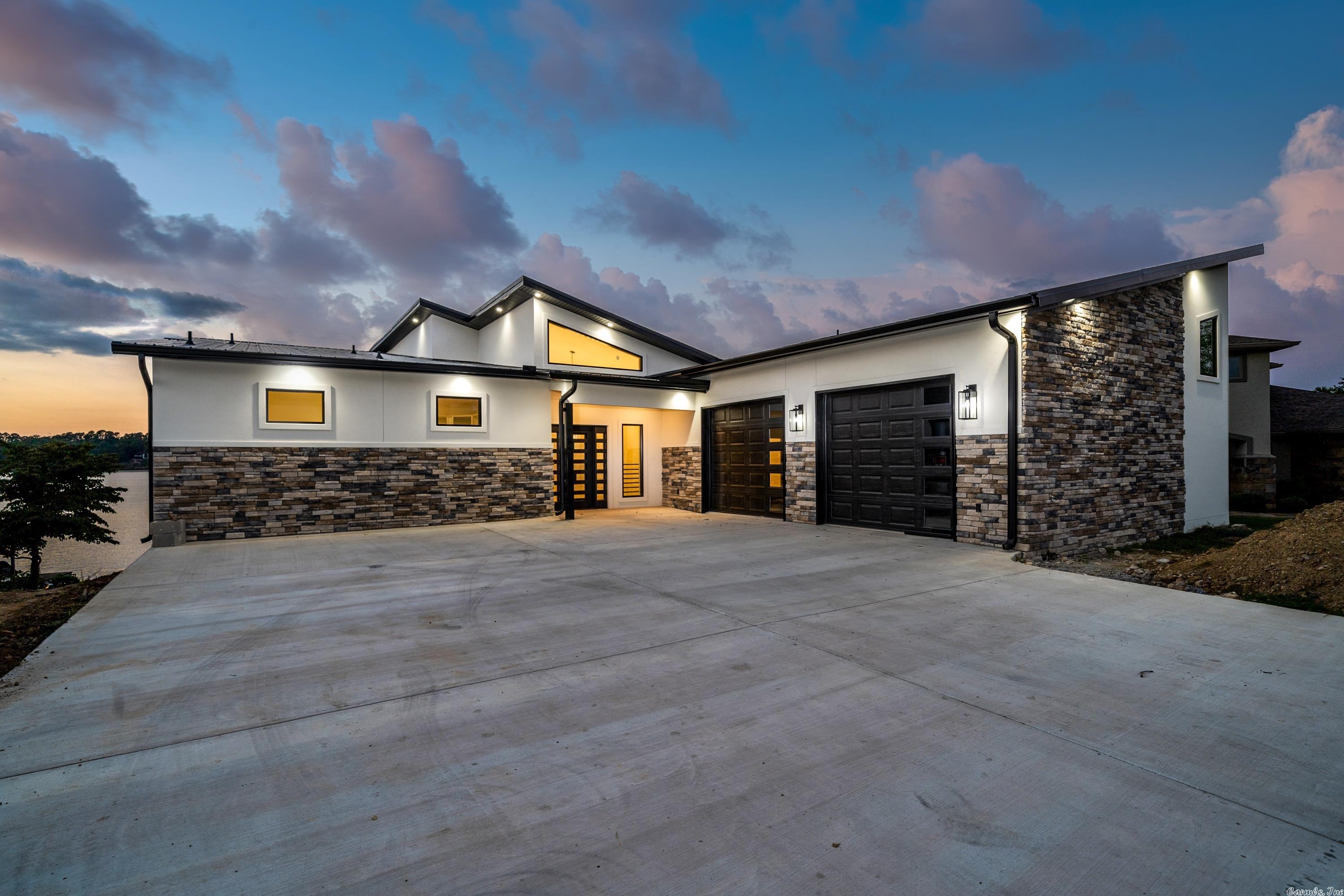 Stunning NEW CONSTRUCTION on Lake Hamilton. Distinctively stylish with contemporary design elements and magnificent MAIN CHANNEL VIEWS from every room. Along with an open floor plan, soaring ceilings and upscale finishes, the home features a media room with kitchenette, quartz countertops, luxury Zline appliances, Thor icemaker, and two Navien tankless water heaters. All secondary bdrms have french doors opening to the patio while two have en suite baths. Two stall dock with swim platform and so much more!