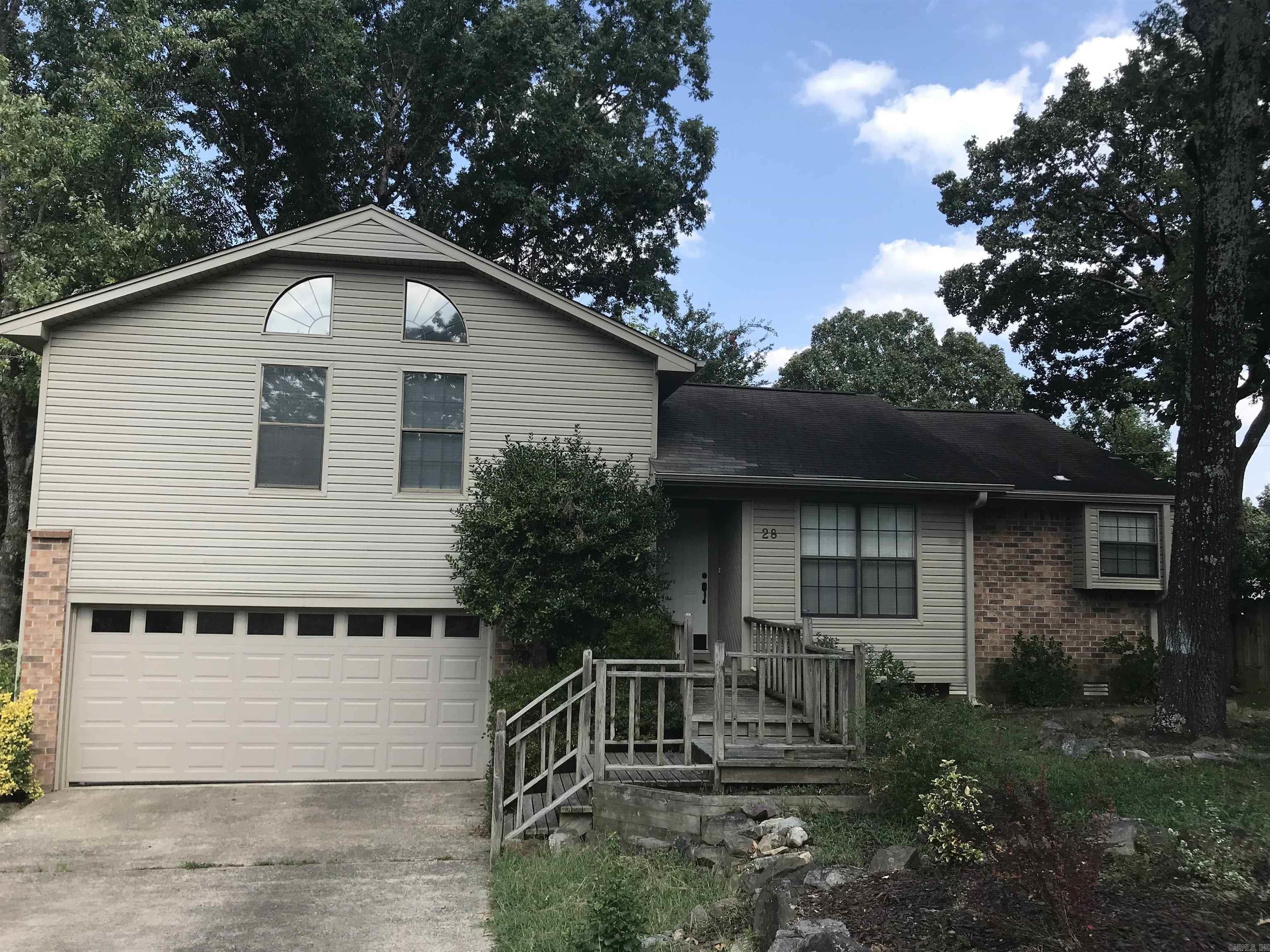 Located in West Little Rock and just minutes from shopping, dining and more! Come discover where convenience meets relaxation at 28 Elkrun Cove. Situated on an spacious lot in a cul-de-sac that backs up to green space! Enjoy evenings near the fireplace and adornments like vaulted ceilings, built-ins, walk-in closets, lots of natural lighting and a floorplan layout you will love! The kitchen is perfect for hosting with a dining area for dinner with guests! Two full size bathrooms to accommodate with a separate area for laundry. Enjoy morning coffee on your back deck and the two-car garage offers additional storage as well. The backyard offers plenty of room for activities throughout the year! This home is primed and ready for you to move in and add your own updates and vision! Schedule a tour today!