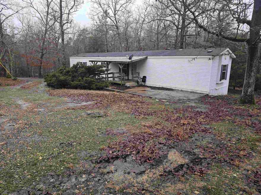 TWO HOMES ON 5 ACRES!!!!  Both homes are 3 bed 2 bath, one is a 2005 with 1216 sq ft and the other is a 1997 with 1404 sq feet.  Both have front and back decks.  Property has a pond, storm shelter, RV hook up, large outbuilding (could be turned into a tiny home) and is partially fenced.  Located directly across from Lake Wilhelmina.  Both homes are in great shape. MAY CONSIDER SUBDIVIDING. Realtor owned. Agents see remarks