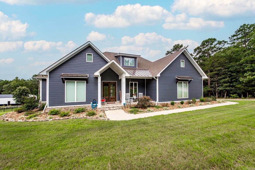 Welcome to this exquisite new construction LAKEVIEW home. Located just outside of Fairfield Bay & less than 1 mile from Fairfield Bay Marina no HOA  Offering a perfect blend of luxury & comfort. Expertly crafted by a local builder for his personal residence, attention to detail is evident throughout. Enjoy a convenient walk easement to the tranquil shores of Greers Ferry Lake. Spacious Living Areas: With 2,316 sq ft on the main floor & an addl 400 sq ft bonus room upstairs, there’s plenty of room for family & guests. Experience the convenience of a large pantry featuring a coffee bar. The heat & air is a dual fuel system. The house is wired for a generator.  Soaring 10' ceilings, upgraded luxury vinyl flooring, & leathered granite countertops create a sophisticated atmosphere. Entertain with family & friends on the covered deck. This home is very energy efficient with spray foam insulation & the Everlast siding & composite decking make this home low maintenance. The programmable sprinkler system will keep your landscaping lush. Keep your family safe with a built-in storm shelter & ample storage is available in the insulated basement & the spacious 30X45 shop. See agent remarks.