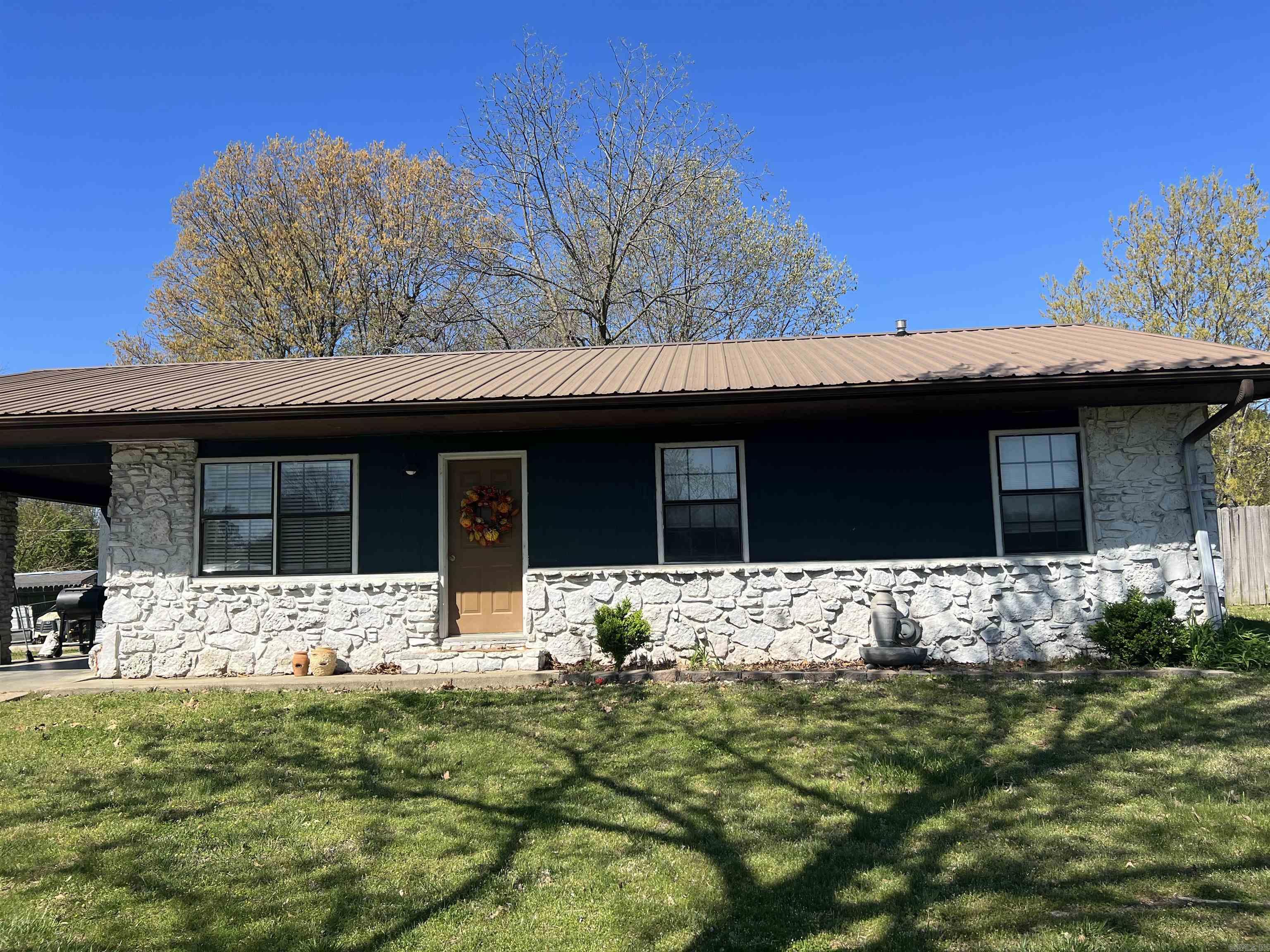 MOVE IN READY Stone Ranch style 2/3 Bedroom 1 bath home located at 308 Marcia in Piggott, AR. This home has a large fenced in backyard and has been PRICED TO SELL! The kitchen has a beautiful tile backsplash and has a breakfast area. The nice sized laundry area is right off the kitchen and has a door to covered carport.The living room is right off the kitchen and has lots of natural light and windows to enjoy the view. This home has beautiful luxury vinyl plank flooring through out. One bedroom has been opened up to create a large bedroom but could easily be converted back to a three bedroom if needed. It has a metal roof, neutral color pallet, and updated lighting throughout. You don't want to miss this home priced BELOW surrounding listings. Seller Motivated! Schedule a time to see it TODAY!