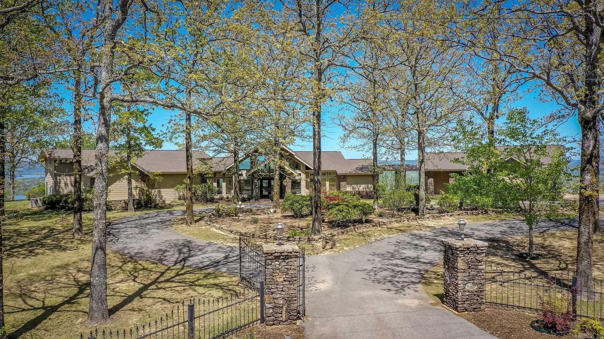 First time ever this one-of-a-kind property has been offered to the market!! Custom built and meticulously thought-out house plans and placement on the bluff with panoramic views from every room is an absolute dream and now can become your reality. Views of the Narrows bridge going into Greers Ferry and beyond as far as the eye can see. Gated entrance to Cliffview Tracts Subdivision provides extra peace of mind. Home has a Generac generator backup for essential things in the home and garage doors. ALL ONE LEVEL with easy maintenance large concrete patio, no deck. Every part of the house is under a covering with a breezeway connecting the full guest apartment and garage. Total under roof sq footage to include the garage is over 5900. Main house has 4 bedrooms and 2.5 baths. Apartment has full bath living area with kitchen and bedroom area. Washer hook up is in garage if you needed a second laundry. The home has city water but also has an over 400 foot deep well for watering plants or to have for your garden. This type of home does not come around often and has to be seen in person to really appreciate its beauty. Agents, please see ALL remarks and must call list agent for address.