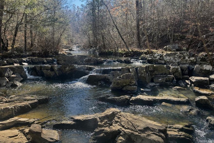 Discover the perfect blend of privacy, natural beauty, and build-ready convenience with this stunning 8-acre vacant land tract. Electricity is already available on the property, and a cleared, flat area with an existing concrete pad offers an excellent potential homesite or cabin location. A well-established trail leads you down to a peaceful creek, where you’ll find a truly breathtaking waterfall—an ideal setting for relaxation, recreation, or simply enjoying the sights and sounds of nature. Whether you’re dreaming of a private retreat, a future homesite, or a weekend getaway, this property offers endless possibilities in a serene, natural setting.