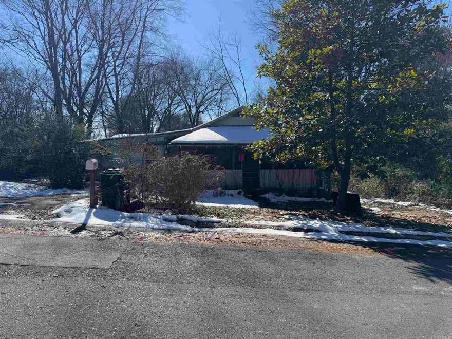 This property is in need of a complete rehab.  It has been tagged by the City of Benton.  The   home has potential;  the main part of the house is much better than the addition. The addition on the left would probably need to be removed, there is a hole in the roof,  on the left side.  The square footage is estimated.  This is a beautiful lot and would make a great place for a home!