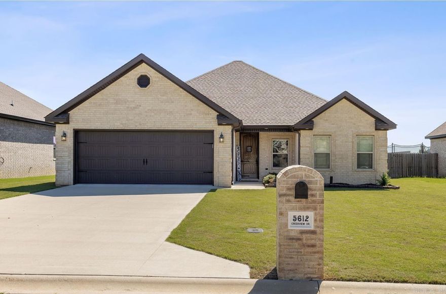 Welcome to the Market 5612 Creekview Dr. located in Jonesboro, Ar in Valley View School District. This home features 3 bedrooms, 2 bathrooms, 2 car garage, and 1859 square feet. Upon entering through the beautiful solid wood front door you enter into the open concept living space with tall ceilings and a beautiful gas fireplace. Luxury vinyl plank floor runs throughout the main living space. This home has plenty of space for entertaining with an open concept living room, dining room and kitchen. The kitchen features white cabinetry with beautiful granite counter tops. You also can not forget the window over the sink looking into your backyard space. The primary suite is located opposite of the two additional bedrooms. Walking into the primary suite you will notice a large room with a coffered tray ceiling and access to your primary bathroom. The primary bathroom features a walk in tiled/stone shower, soaking tub, vanity with dual sinks, and access to a large walk in closet. The additional two bedrooms both feature double door closets with wood built-ins and access to the second bathroom. This home also features a large screened in back porch and grilling pad. Call your favorite REA