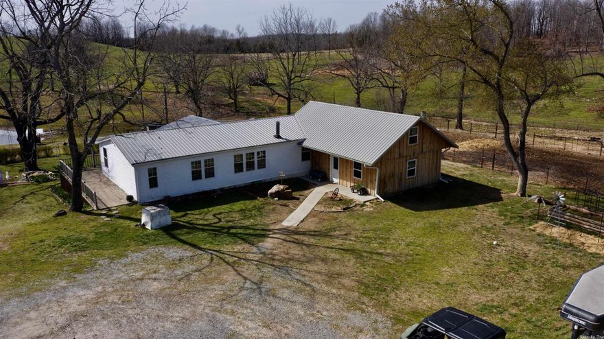 Sitting atop a knoll you will find this 2,100 square foot 3 bedroom, 2 bath manufactured home with a 20'x24' custom addition on the back perfect for the family. With a full-length back porch, you can sit and drink your coffee while overlooking one of the many ponds on the property and take in your morning views as God’s creation begins to awaken.   Out in the yard are two additional outbuildings that are included in this offering. The largest of the two is a 42'x72' fully enclosed barn ready for your horses or other farm animals containing 4 box stalls, 12 tie stalls, and a tack room! Adjacent to the home is a large workshop that is currently being used for metal fabrication. A 35'x72' portion of the shop has concrete flooring and is where the current fabrication takes place. With large ceilings and multiple doors, the possibilities are endless for whatever creative hobby or work needs to be done.  Out on the farm, you will find a neatly groomed landscape that surrounds the home that includes 5 different ponds strategically fenced around to provide water in each pasture, along with 3 springs that run for the majority of the year.