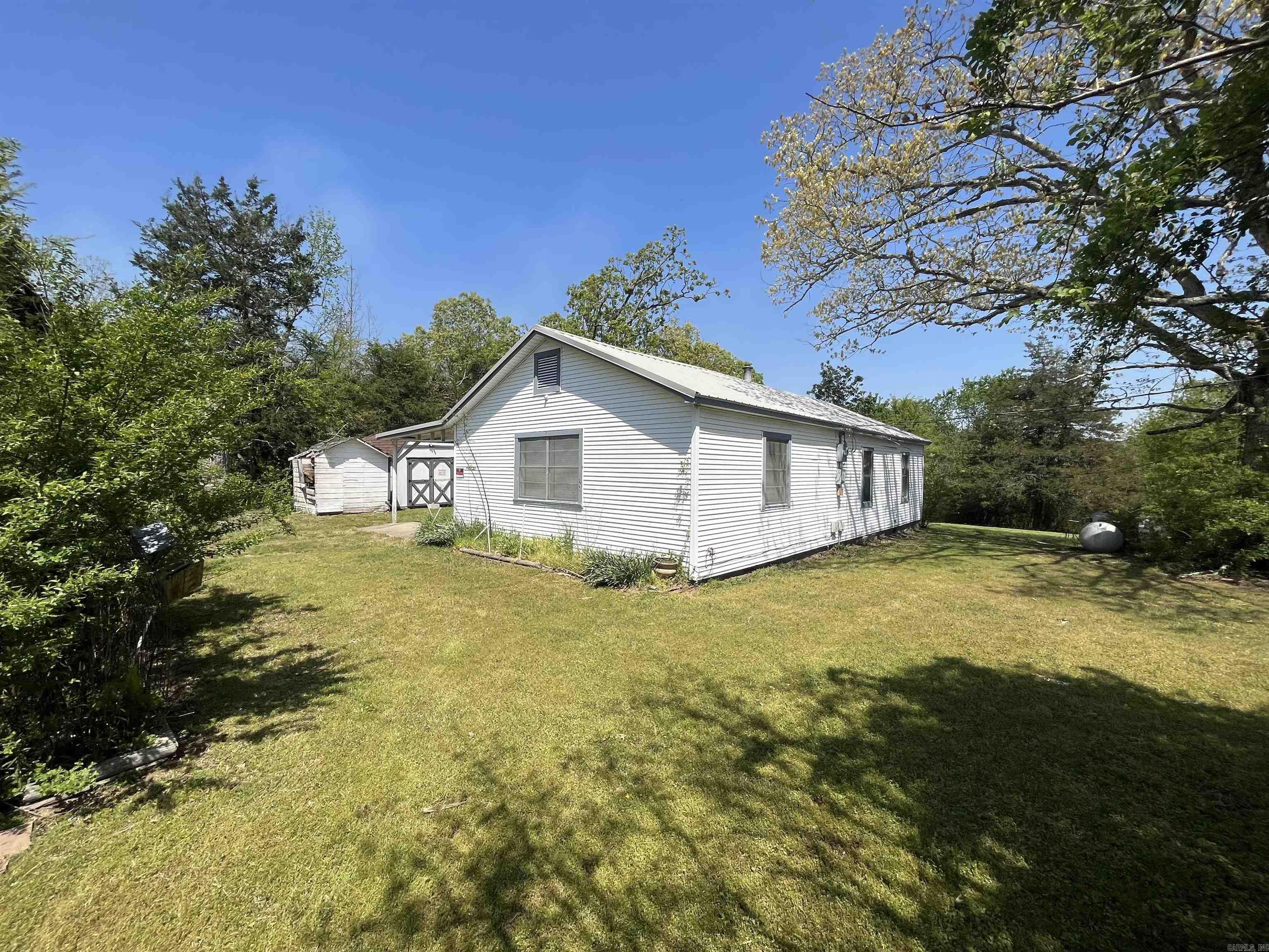 Spacious fixer upper on nearly 2 acres! New Roof in 2024! Very close to town but still has the country feel! Has well and access to rural water! This property has tons of potential!