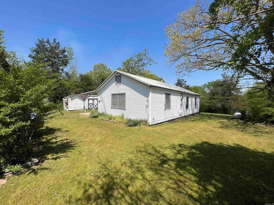 Spacious fixer upper on nearly 2 acres! New Roof in 2024! Very close to town but still has the country feel! Has well and access to rural water! This property has tons of potential!