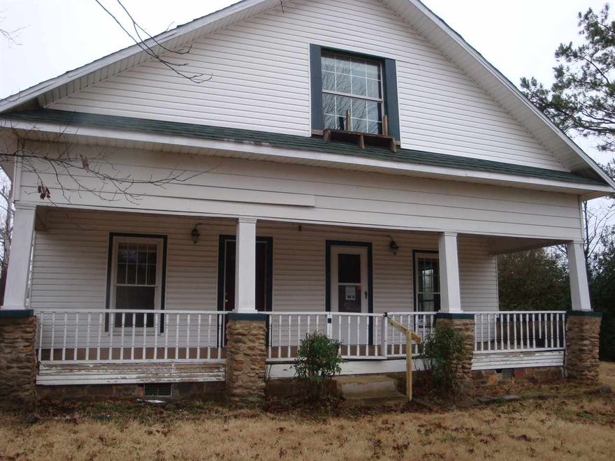 Curb appeal is only the beginning of this charming house, which also has a shop, three bedrooms, a formal dining room and sits on six city lots. Second floor has two large rooms -- bedrooms or bonus rooms. First floor has four rooms and a kitchen in the center. See agent remarks.