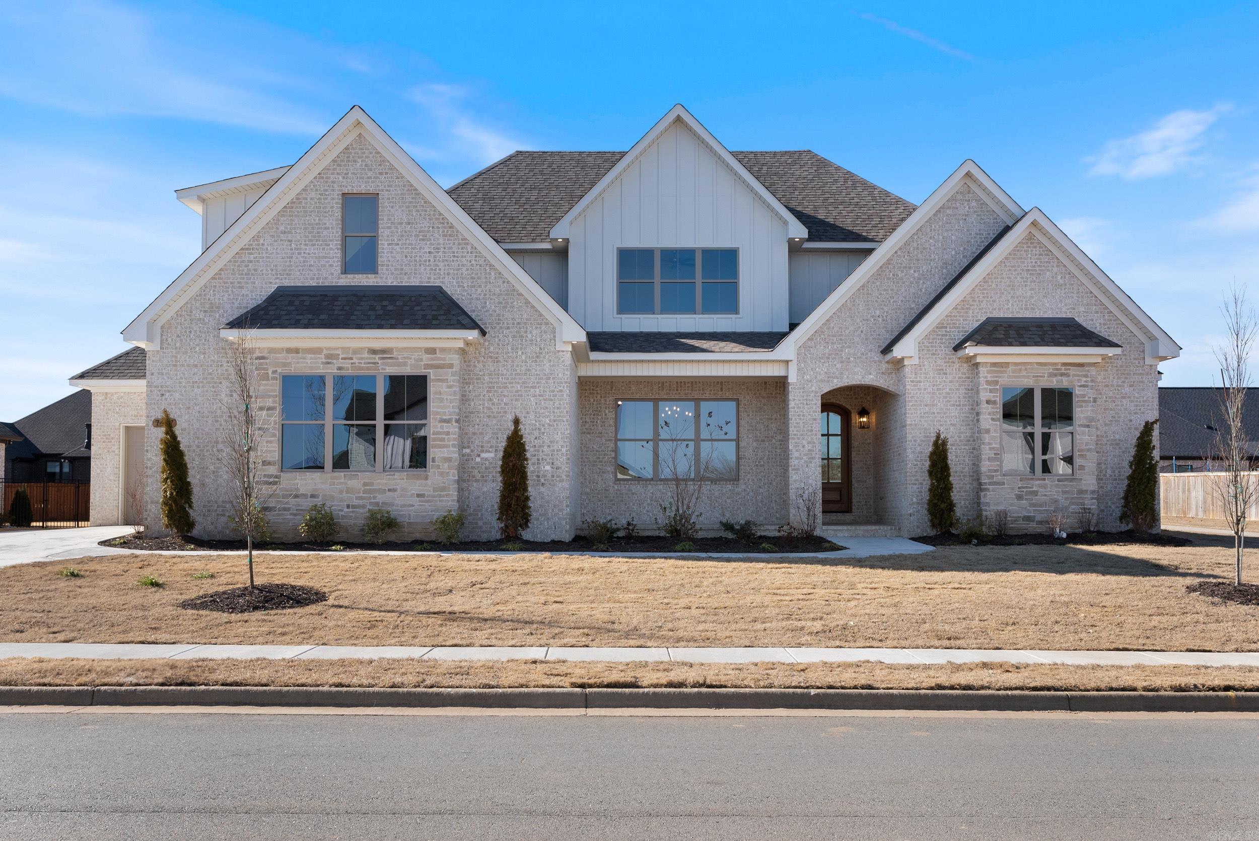 Beautiful new construction with a French Country Style and versatile/unique layout. Living room features gas fireplace and vaulted ceilings with wood beams. Large kitchen island, stainless steel appliances, hidden walk-in pantry. One separate dining area. Primary Suite features cathedral ceiling, ensuite has freestanding tub and custom tile walk-in-shower. Another room downstairs for a bedroom or office and full bath. Upstairs features 2 bedrooms and a spacious bonus room or 5th bedroom. Mudroom, spacious laundry room, tankless water heater, large covered back porch with wood burning fireplace. 3 Car garage (double car and a separate single car). All this in a great subdivision with amazing amenities as well! Pool, clubhouse, tennis courts, pickleball courts, playground and beautiful lake! Call for your personal tour today!