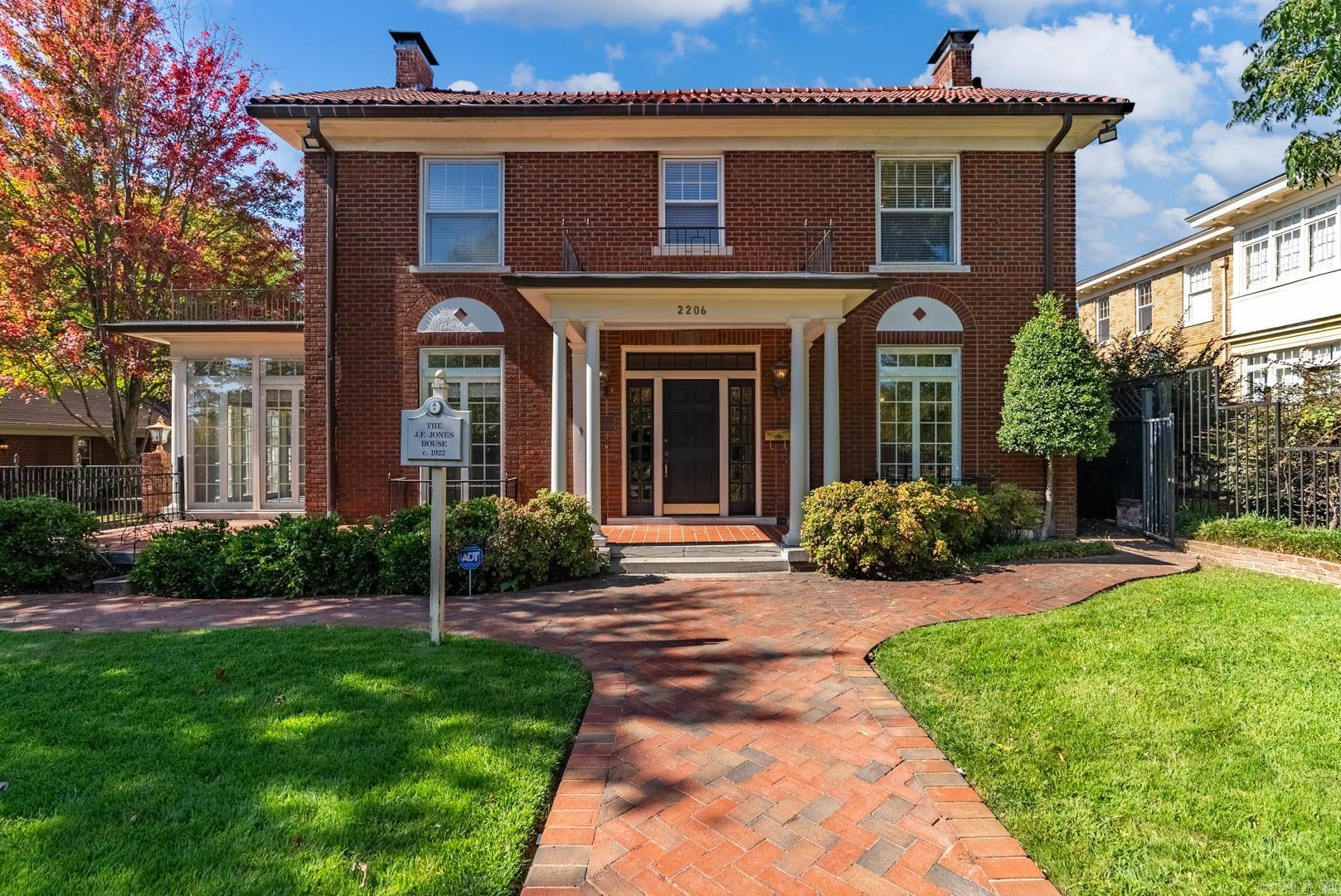 This exquisite property includes two brick homes on two spacious lots surrounded by beautiful iron fencing with landscaping and gardens that add elegance and privacy. These meticulously maintained homes offer a unique blend of historic charm and modern amenities. The spacious main residence (2948 SF, 3 BR/2.5 BA) is perfect for family living and entertaining, with gorgeous vintage touches and hardwood floors. Main level has formal living and dining rooms, sunroom, kitchen, large den open to back/side yards, wet bar, laundry, half bath. Upstairs are primary suite with dressing room, two large bedrooms and a sunroom. Floored attic and basement provide storage or opportunity to finish out for more living space. The additional dwelling unit, once a carriage house, (941 SF, 1 BR/1 BA) has been fully renovated into a charming one level one-bedroom, one-bath home with two living areas, ideal for guests, in-law quarters or income potential. The grounds are lovely, with plenty of parking and two-car garage. Come see this rare opportunity to own The J.F. Jones house, c. 1922, a piece of Little Rock’s heritage with flexibility and style in the heart of historic Downtown. *Agents see remarks.