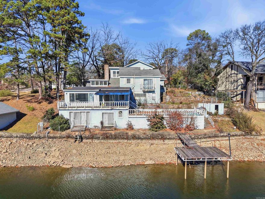 Prime Lake Hamilton Opportunity! This exceptional 1.38-acre lakefront property is located within the Hot Springs city limits and offers approximately 105 feet of frontage on Lake Hamilton in the desirable Burchwood Bay area. Conveniently accessible by both boat and car, the property currently features access from Waterside Lane, with additional potential access from Twin Points Road, as the lot extends nearly 600 feet to the rear. This home offers the option for a full renovation or removal, providing a blank canvas for developers or buyers looking to build a custom lakefront retreat. Surrounded by natural beauty, this property presents a rare opportunity to create a one-of-a-kind lake oasis in a prime location. A must-see property with endless possibilities, schedule your private showing today and explore the potential of this Lake Hamilton gem.