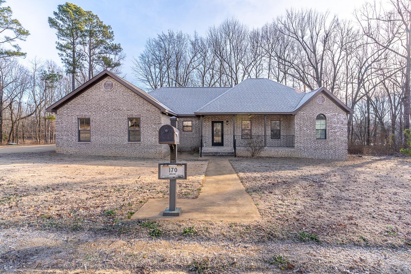 Welcome to Market 170 Greene 338 Rd of Jonesboro, AR of the Lake Lorado Heights Subdivision within the Greene County Tech School District. Situated on a 1.10 +/- acre lot just minutes from Lake Frierson State Park is a 2019 built all brick beauty, topped w/ architectural shingles, and accented by a covered front porch, screened back porch w/ gorgeous tree lined views, 2 car side entry garage, and generator. The interior features 1,734 sf of well laid out living space on 1 level. The open concept, split floor plan contains a living room w/ tray ceiling and rich crown molding, kitchen w/ granite topped island w/ storage & bar seating, stainless steel appliances, and access to the porch. The Master wing holds a generous Master bedroom w/ access to the safe room, vaulted ceiling, walk-in closet and an ensuite w/ dual vanity, custom tiled walk-in shower, and garden tub w/ tile surround, office/flex room, laundry room w/ sink and tankless water heater, and access to the garage. The guest wing holds 2 bedrooms and full bathroom w/ custom tiled walk-in shower. You'll love the scenic location w/ the convenience of Jonesboro & Paragould proper nearby. Call today to make this house your home.