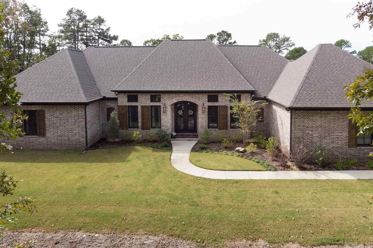 Tranquil design & attention to detail abound in this custom 1 lvl home on 5+AC in beautiful Chenal Downs! Gorgeous wide plank floors, beamed & coffered ceilings & serene covered outdoor living w/heaters overlooking pool & wooded yard! Chef's kitchen w/SS Thermador appl., custom storage, pantry & fabulous slab granite island. Study, Great Rm w/rock gas FP, Den, Dining & unbelievable wine rm. Spilt floorplan w/2 BDRMS w/shared bath, guest suite & awesome Mstr suite! Huge Laundry. Floored attic. Come see!