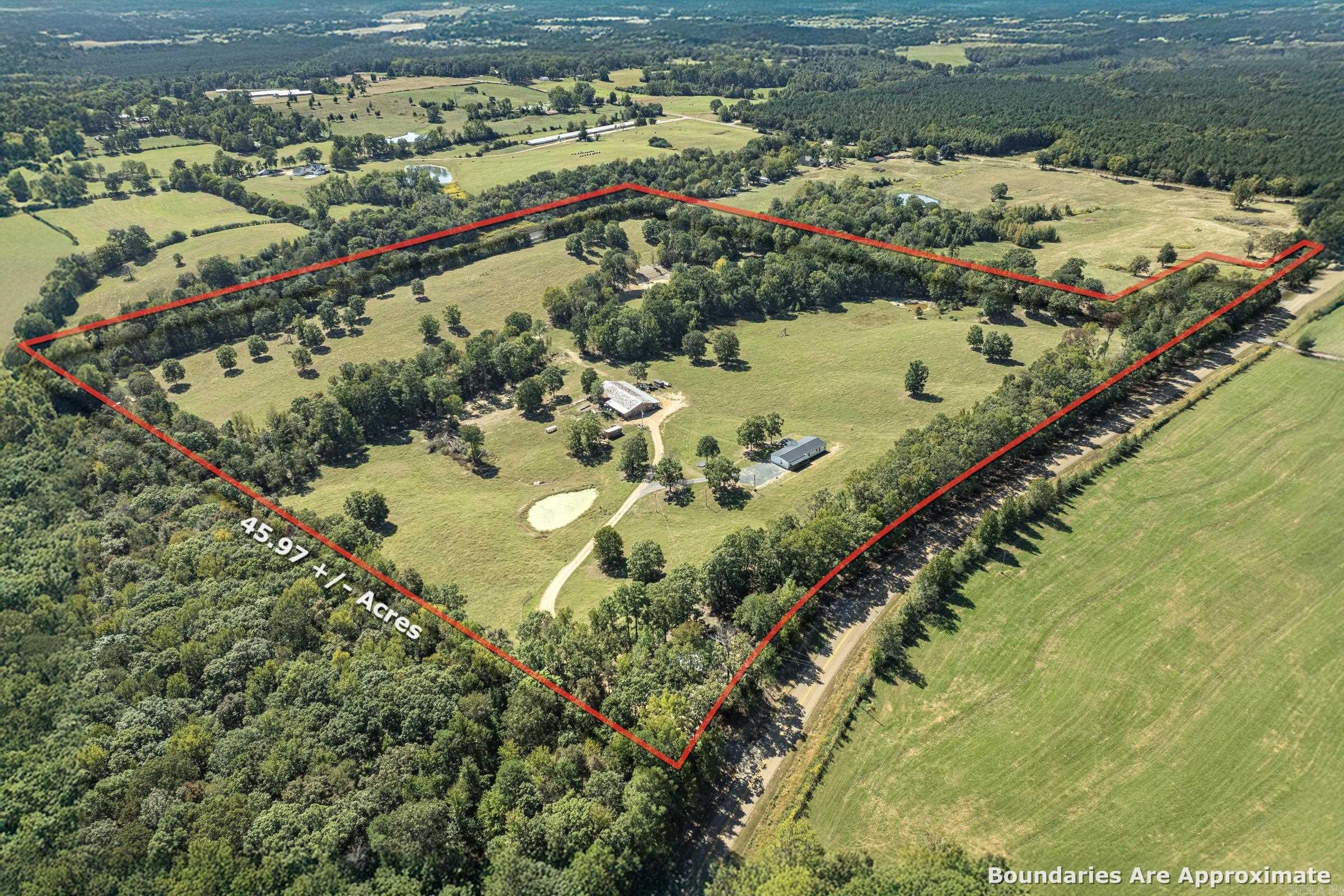46.15-acre farm, featuring a 3BR/2BA custom home with 2280sq.ft, plus a 20x30 cabin, 50x40 insulated barn, concrete floors, electrical, with sheds on both sides of the barn. The farm includes cross-fencing, corrals, chicken coop, dog kennel, four ponds, three pastures, and a year-round creek. These features allow for rotational grazing and can accommodate 45-50 cattle. The home offers a spacious living room with fireplace, office, gourmet kitchen, primary suite with soaking tub, tile shower, and walk-in closet. Covered front and back porches provide views of rolling pastureland. Property is close to Shady Lake, Cossatot River, Caddo River and Lake Greeson all excellent for camping, hunting, and fishing. This exceptional farm offers everything you need for a productive homestead, working cattle farm, or private country retreat.