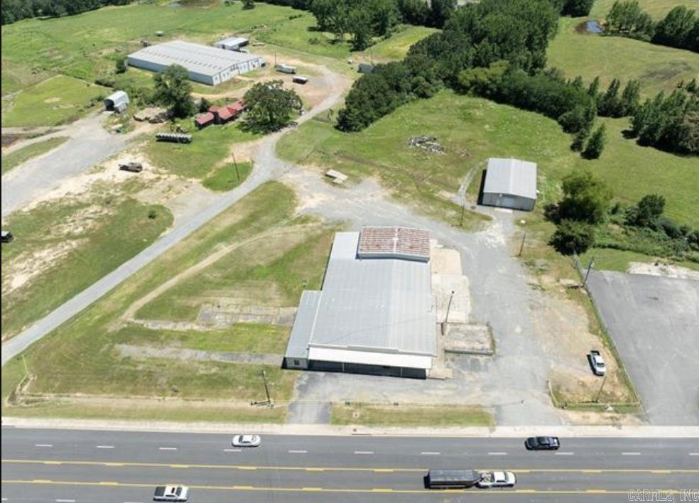 Positioned directly on Highway 65, this property offers excellent visibility and accessibility for industrial users, distributors, or service-based businesses. The site features two buildings totaling over 16,000 square feet on 3.5 acres, providing flexibility for operations, storage, or future expansion.  The main building spans approximately 12,700 square feet, offering a mix of open production space, warehouse capacity, and office areas suitable for a variety of uses. A separate 3,750-square-foot warehouse adds additional storage or workshop functionality.  With ample parking, large yard space, and highway frontage, this property is ideal for businesses looking to serve Central Arkansas and beyond.