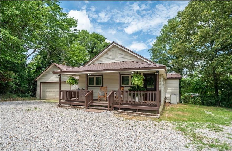 Charming 3-Bedroom, 2-Bath Home in Lake Hamilton School District!  Nestled in the desirable Lake Hamilton School District and conveniently located just off Airport Road, this cozy 3-bedroom, 2-bath home offers the perfect blend of convenience and peaceful country living.  Boasting 1,488 square feet of thoughtfully designed space, the home features updated appliances, a detached garage, a storage building, and ample outdoor living areas—including a welcoming front porch and a spacious deck ideal for relaxing evenings or catching fireflies under the stars.  You will LOVE the front living room with its warm wood ceiling and large windows that fill the space with natural light—it's a perfect spot for both relaxing and entertaining.  From its unique touches to its inviting atmosphere, this home is move-in ready and just waiting for you to make it yours. Come check it out today!