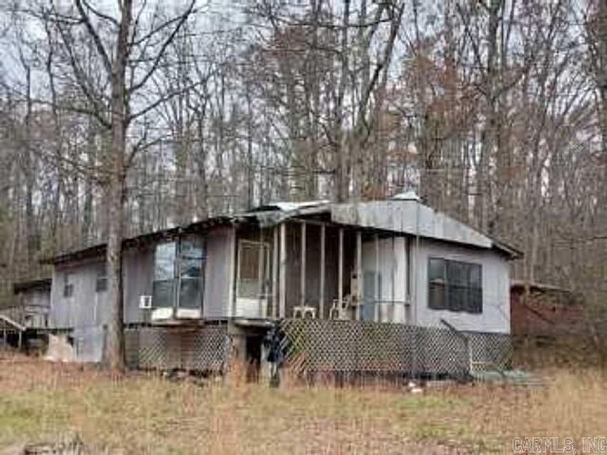 Roll up your sleeves and create your own peaceful retreat on this nearly 5 acres of land with a double wide manufactured home. The home has 4 bedroom and 2 bathrooms. Selling as-is. Looking for a nice piece of land approx. 15 minutes from MTN View and only about 30 to beautiful Heber Springs and Greers Ferry Lake. Check out this Mobile home that is in need of repairs. Owner has a real estate license in FL.