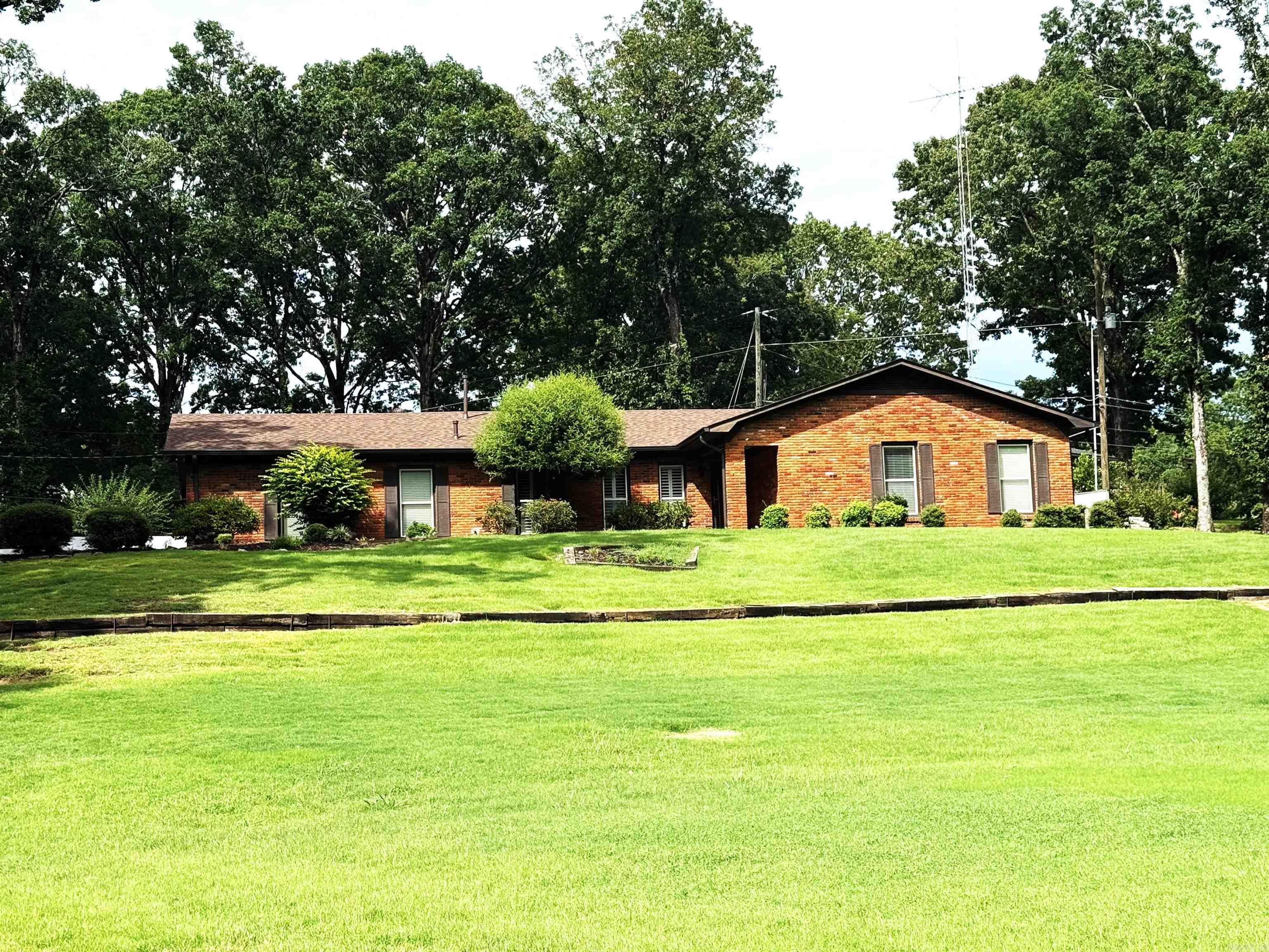 This new listing on Hess Lane has everything a family could need! Sitting on 1.6 private acres, the property includes a 3 bedroom, 2 bath home with a screened porch and outdoor kitchen, a nice patio, fire pit area, 30 x 30 shop divided into a spacious man cave/teenager room and garage or shop, and a generator. The kitchen has been updated with stainless steel refrigerator, dishwasher, stove, under counter water filter, recently painted cabinets and has adjoining bar area with KitchenAid ice maker with water filter. The spacious family room featuring a unique electric fireplace is open to the kitchen and has a door to the screened back porch. A dining room and living room with beautiful hardwood floors and plantation shutters are on the front of the house. The entry has a nice closet and tile floor. A hall bath is off of the entry and 2 nice bedrooms are on east end of house, one one walk-in closet. The primary bedroom is spacious with wonderful custom, walk-in closet and updated bath with large walk-in tile shower and new vanity. New double pane windows were installed approximately 10 years ago, and 2 car garage has 2 storage rooms and garage door with new controller.