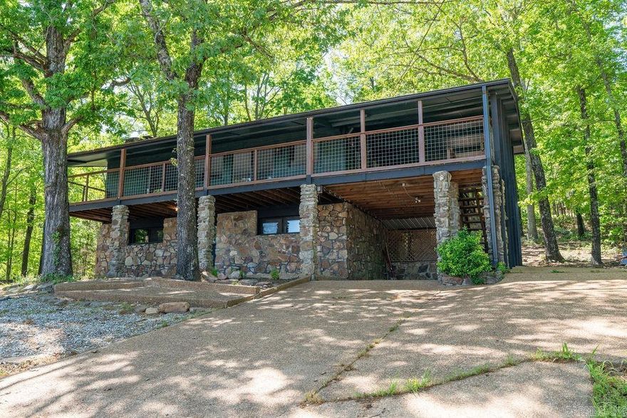 Fully renovated and beautifully designed, this 4-bedroom, 3-bath home offers stunning, distant views of Greers Ferry Lake in the spring/summer and even more expansive views in the winter, 2,610 sq ft of modern living space across two levels. 2 bedrooms and optional 3rd or den/sunroom/study upstairs, with one bedroom, sitting area and bath downstairs. Completed in September 2024, updates include all-new flooring, a stylish kitchen with new appliances, open concept, updated bathrooms with tasteful design features, interior/exterior paint, and beautiful tile-floored deck perfect for outdoor dining while taking in the view. The home features two fireplaces, a great room, and a game/den area. Enjoy a spacious 36' x 6' main deck, a fire pit lounge area, and landscaping upgrades. Inviting back decks with the cozy feel of the wooded area surrounding the home. The roof was replaced in 2018, gutters in 2023. A carport and additional parking pads offer plenty of space for guests. Ideal as a primary residence or short-term rental—permit will need to be obtained. Private septic means no sewer fees, and resort amenities add extra appeal. Take a look at this gorgeous home.