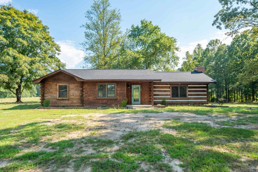 Discover your perfect retreat on two sprawling acres where tranquility meets modern comfort. This charming 3 BR's, 2 Ba. log home offers 1,487 sq. ft. of thoughtfully updated living space that feels both cozy and spacious. The recent renovations throughout ensure you can move right in without lifting a finger, unless it's to wave hello to the deer that might wander through your expansive yard. The peaceful private setting provides the ideal escape from bustling city life, while still maintaining convenient access to everyday amenities. This property strikes the perfect balance between comfortable country living and room to breathe. Welcome to your slice of Arkansas paradise.