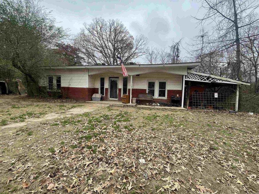 Fixer Upper Opportunity on .82 Acres!  This small fixer upper sits on a solid cement slab and offers a great opportunity to create your ideal home or next investment property. This property features .82 acres of usable, cleared land with of room to expand, garden or enjoy the quiet country-like setting. This home is in need repairs and updates, making it the perfect project for those looking to add value and customize to their tastes. With a peaceful rural fee and the convenience of town, this property offers both potential and location.