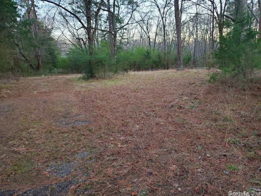 Beautiful wooded acreage. Hwy 71 frontage. Old well on property.  Acreage to be surveyed to determine exact acreage/price will be $9,000.00 per surveyed acre.