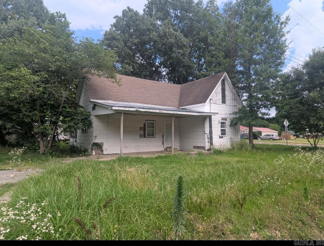 Traditional, affordable home with a spacious yard and plenty of trees for shade. Home sits on a corner lot with a covered side porch.
