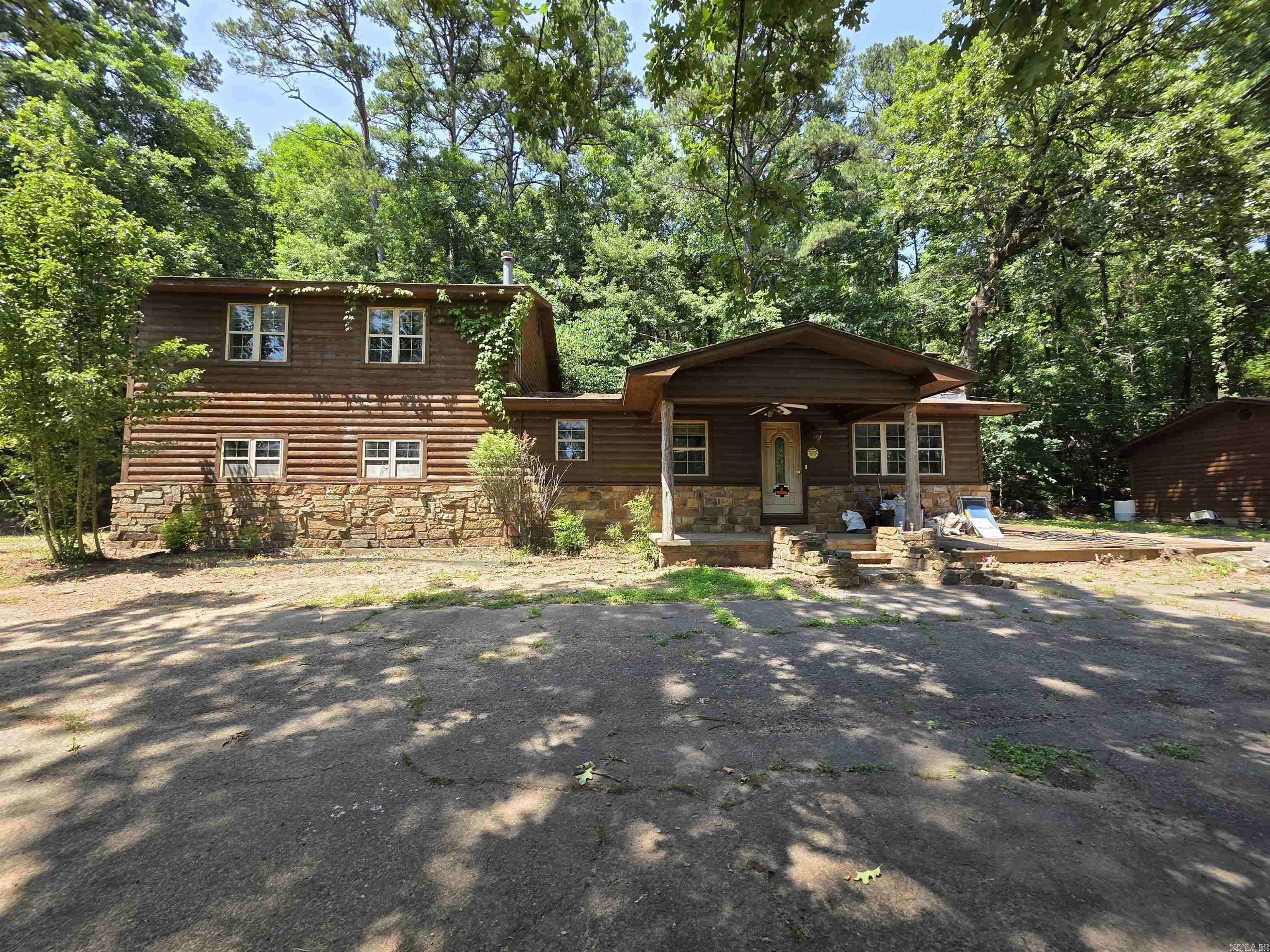 This 4 bedroom, 2 bath story and a half home near Lake Dardanelle has log siding and matching 3 car detached garage with openers on both doors. The 2.5 acres m/l setting is private, tranquil, and just minutes to town and to Lake Dardanelle, marina, and boat ramp. Kitchen/dining/ living, den, utility, 2 bedrooms and a full bath are downstairs. Upstairs there are 2 large bedrooms and a full bath.