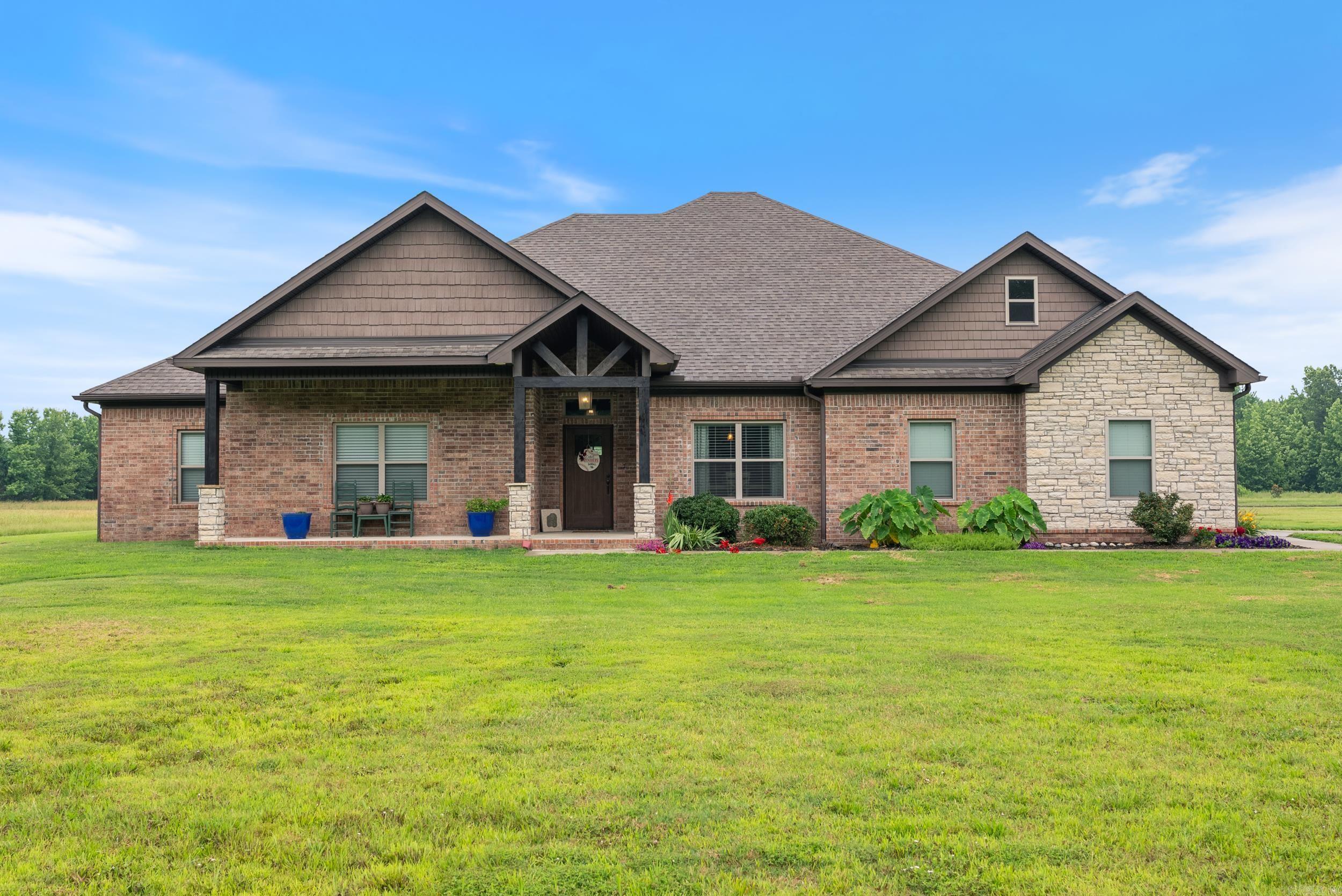 Welcome to your beautiful, custom home on just under 20 acres with pond, shop & thoughtful upgrades throughout. Open-concept layout with vaulted, beamed ceilings, stained concrete floors & wood-burning fireplace with a gas starter. The kitchen features granite countertops, double ovens, 5-burner gas stove, walk-in pantry & butler’s pass to the formal dining. The spacious primary suite features a beamed ceiling, dual closets, with a built-in gun room, & luxurious bath with double vanities & oversized dual-head rain shower. All bedrooms have walk-in closets with built-ins. You'll also find a bonus office, upstairs flex room & oversized laundry with storage. Outside, you'll find a covered front & back porches, grilling area, 1-acre stocked pond, mature trees, and wired shop with oversized garage door. Enjoy privacy, wildlife, and modern comfort just minutes from town and Cabot Public Schools! Agents, please see remarks.