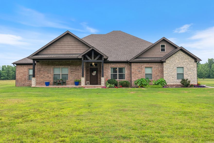 Welcome to your beautiful, custom home on just under 20 acres with pond, shop & thoughtful upgrades throughout. Open-concept layout with vaulted, beamed ceilings, stained concrete floors & wood-burning fireplace with a gas starter. The kitchen features granite countertops, double ovens, 5-burner gas stove, walk-in pantry & butler’s pass to the formal dining. The spacious primary suite features a beamed ceiling, dual closets, with a built-in gun room, & luxurious bath with double vanities & oversized dual-head rain shower. All bedrooms have walk-in closets with built-ins. You'll also find a bonus office, upstairs flex room & oversized laundry with storage. Outside, you'll find a covered front & back porches, grilling area, 1-acre stocked pond, mature trees, and wired shop with oversized garage door. Enjoy privacy, wildlife, and modern comfort just minutes from town and Cabot Public Schools! Agents, please see remarks.
