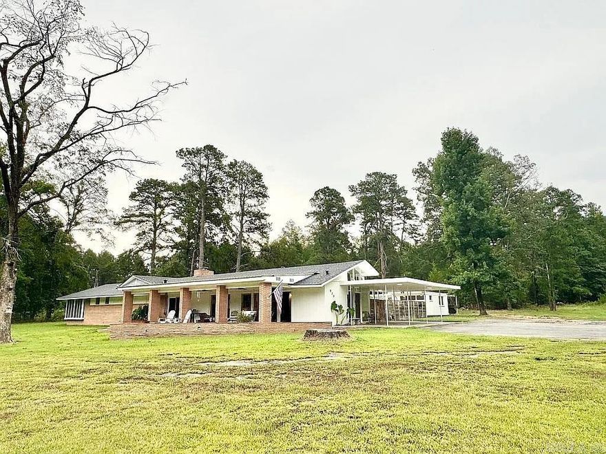 Set on 4 secluded wooded acres in Fordyce, AR, this mid-century modern estate offers a rare combination of architectural character and modern upgrades. The 2,832-square-foot main house features 4 bedrooms and 2 bathrooms, with a spacious open layout, vaulted ceilings, and rich wood-accented interiors that bring warmth and light into every room. The fully renovated kitchen is a standout, with quartz counter tops, premium cabinetry, and a layout designed for both function and gathering. Every major system has been updated—roof, plumbing, electrical, HVAC—along with new flooring, lighting, and paint throughout. The master bedroom is a true retreat, complete with its own screened-in porch overlooking the pond—perfect for morning coffee or winding down at sunset. A separate 600-square-foot guest house adds incredible flexibility, featuring a full kitchen, full bathroom, living room, bedroom, and its own washer and dryer. The property also includes a 16’ x 25’ metal workshop with utilities, ideal for creative projects or storage. With a two-acre pond, asphalt driveway, and stunning natural views, this home is a private sanctuary designed for comfort, style, & connection to the outdoors.