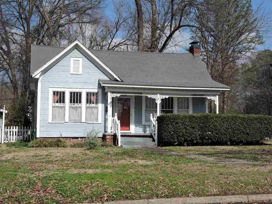 Cute home with Old Town Conway charm, large covered front porch with swing, wood floors throughout, large family room with fireplace and shelves, formal dining room, spacious kitchen with all kitchen appliances, fenced yard with storage building.