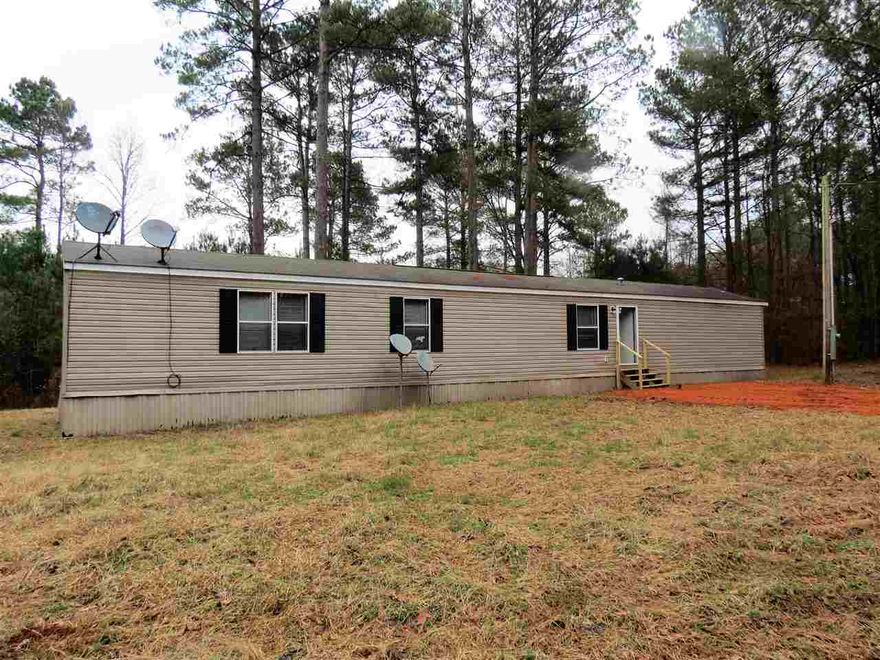 10 acres in Cleveland County with a single wide mobile home that looks brand new!!!  New carpet, new flooring, new paint, ready for new owners to move in!!  Open floor plan with island in kitchen, large laundry room.  Split floor plan with master on one end.  Large master bathroom with garden tub, separate walk in shower.  Home sits on a long driveway with new gravel.  Survey shows how home sits on front of land, plenty of room to build a home in the future.  Possible owner financing.  Call me today!!